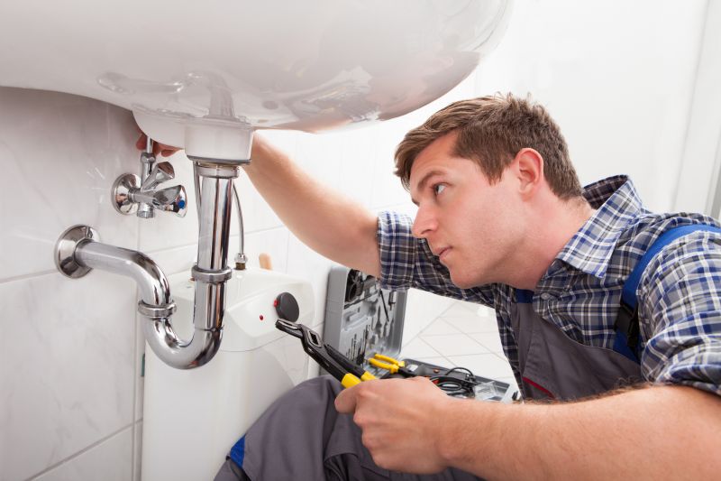 Plumber Fixing a Pipe